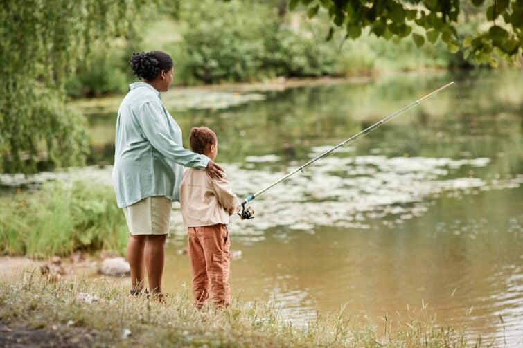 WaterFest event image of mother and daughter fishing in a river.