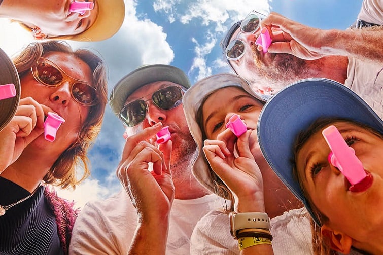 All together now festival image of people playing Kazoos.