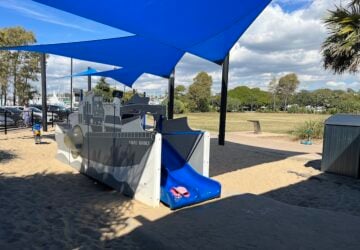 HMAS Manly play structure, sand and shade sails at Bayside Park.