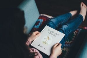 teenager reading a book borrowed at the library