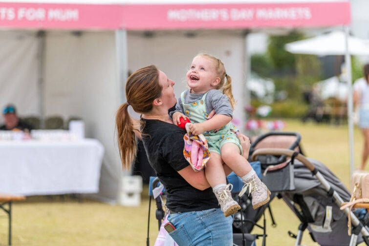 Brookhaven Mothers Day Market event image of mum picking upi her daughter at the markets.