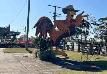 Big entry sign which is a bird with a hat on at Capalaba Produce.