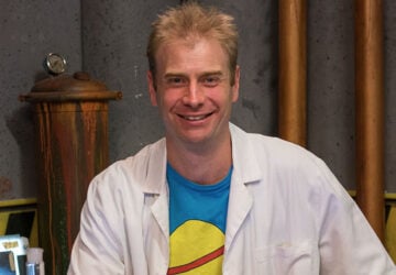 Dr Rob Bell Experimentary with space shirt and lab coat on.