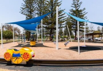 Pratten Park Broadbeach playground with monorail track and shade structures.