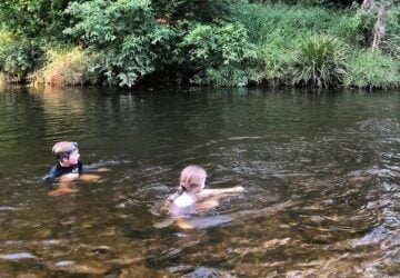 edward allison park creek play, 2 kids in the creek swimming.