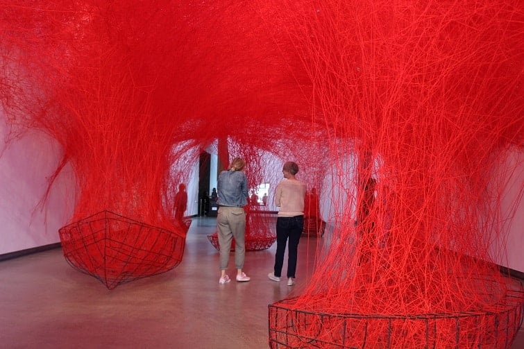 gallery of modern art brisbane, art exhibition, red strings attached to ceiling.
