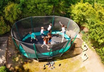 Group of kids on large trampoline.