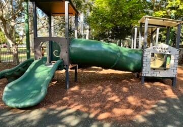 Toddler playground with tunnel and slides at John Scott Park.