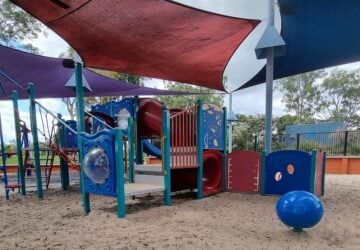 Playground with shade sails and sand base at John Walker Place in Yeronga.