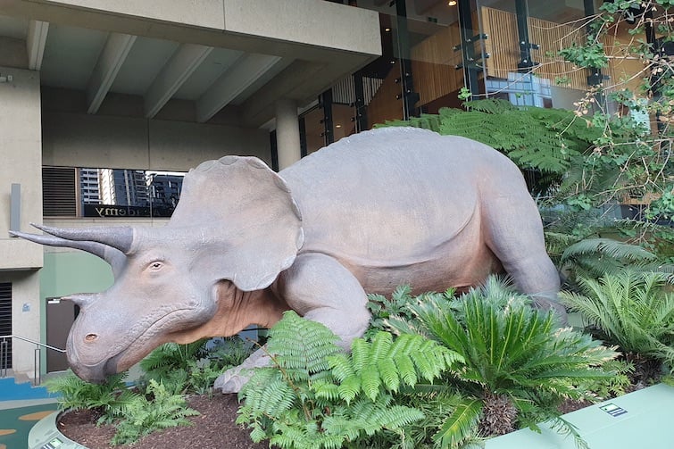 A dinosaur outside in the Dinosaur Garden at Queensland Museum.