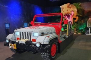 A Jeep and t-rex made of LEGO at Jurassic World by Brickman.