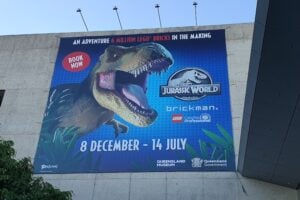 The sign outside on the museum for Jurassic World by Brickman.