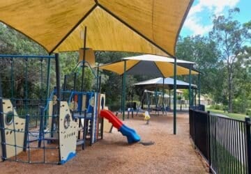 Slide, rockers and playground under shade sails at Lockrose Street Park.