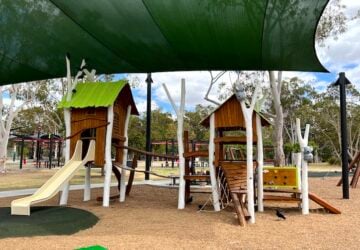 Toddler fort playground covered by shade sails at Logan Gardens Park.