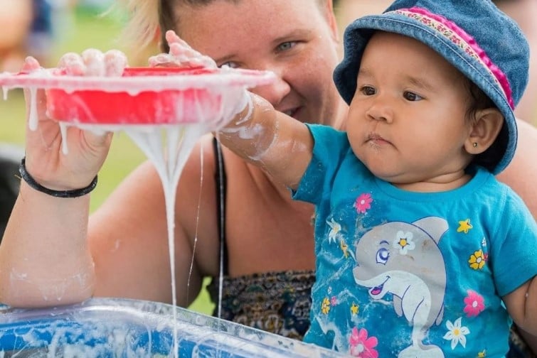 Messy play matters event image of mother and child playing with slime.