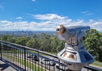 Coin operated binoculars and a view of Brisbane City from Mt Coot-tha Lookout.