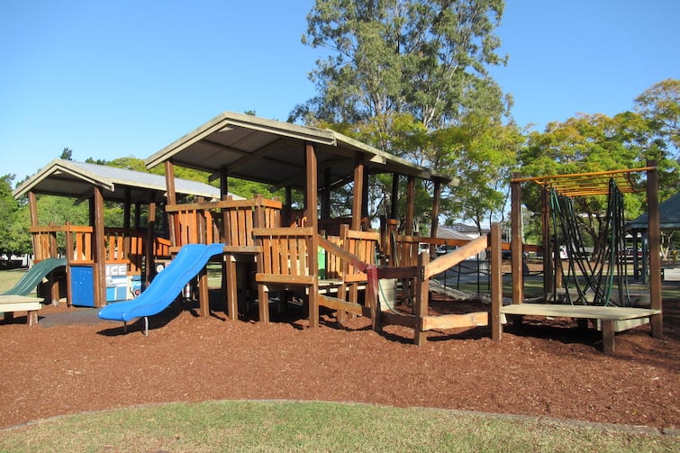 Wooden fort playground with slides at Mulbeam Park.
