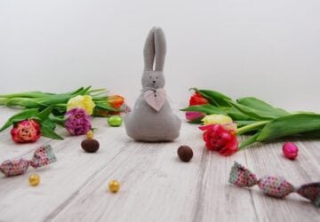 Easter scene with a felt rabbit, flowers and chocolates