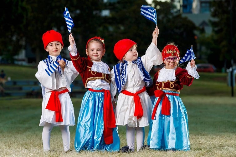 Paniyiri greek festival image of two boys and two girls in traditional Greek outfits.