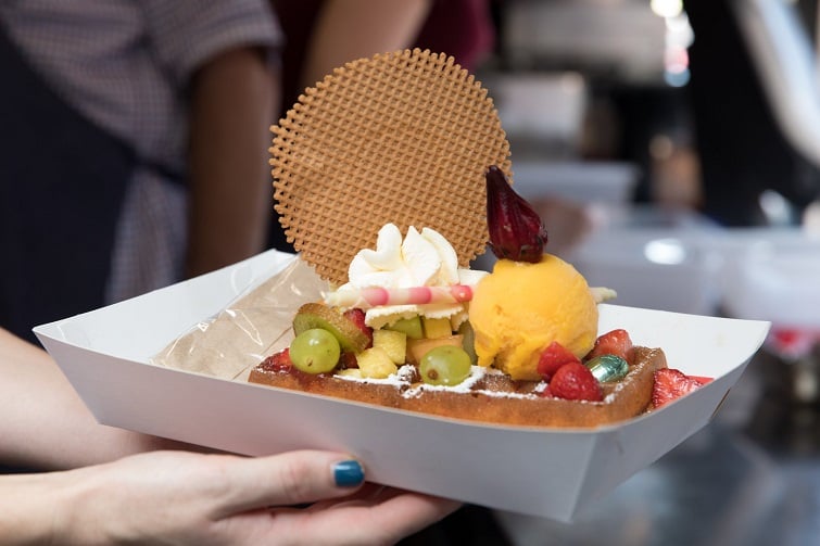 Pop up icecream festival image of ice cream with fresh fruit and waffles. 