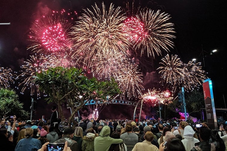 Seafire event image of lots of red and gold fireworks in the night sky over Surfers Paradise with the crowds watching on.