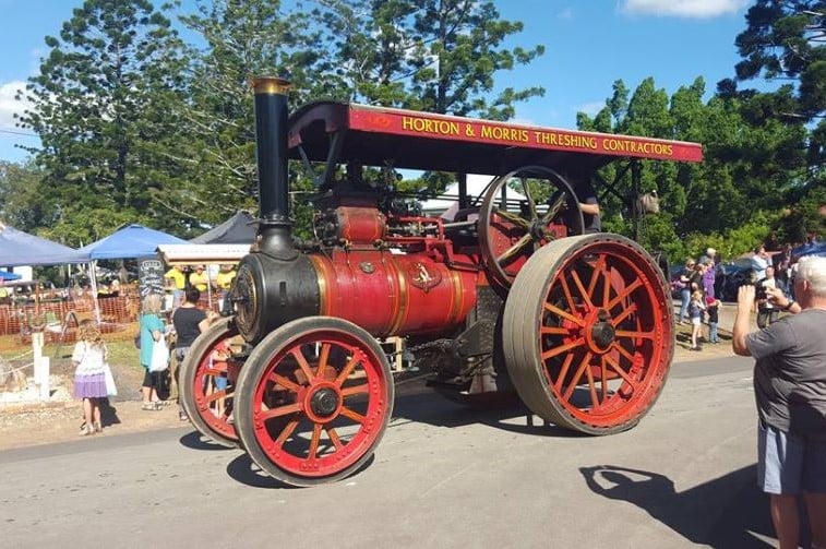 Steam fair event image of old red steam engine.