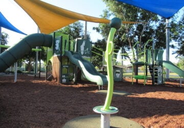 Playground with spinner in foreground at at Symphony Crescent Park.