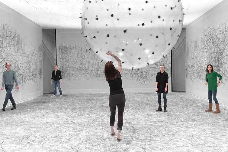 Five adults viewing an art installation from World Science Festival Brisbane 2024.