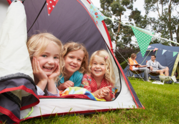Camping gift ideas for kids three girls in tent parents behind.
